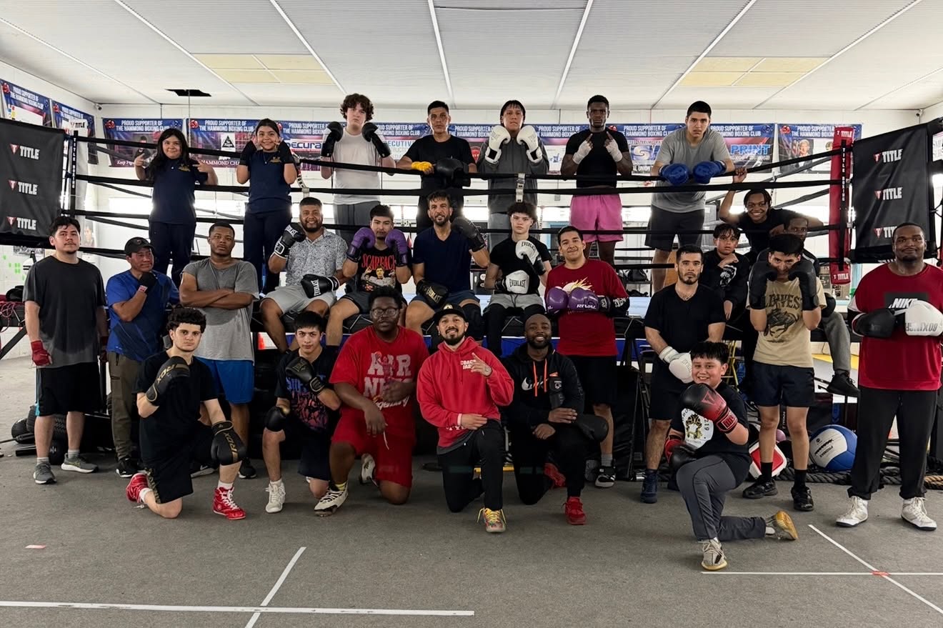 The full Hammond Boxing Club team — roughly two dozen coaches, teens and adults — gathered in and around the club's boxing ring.